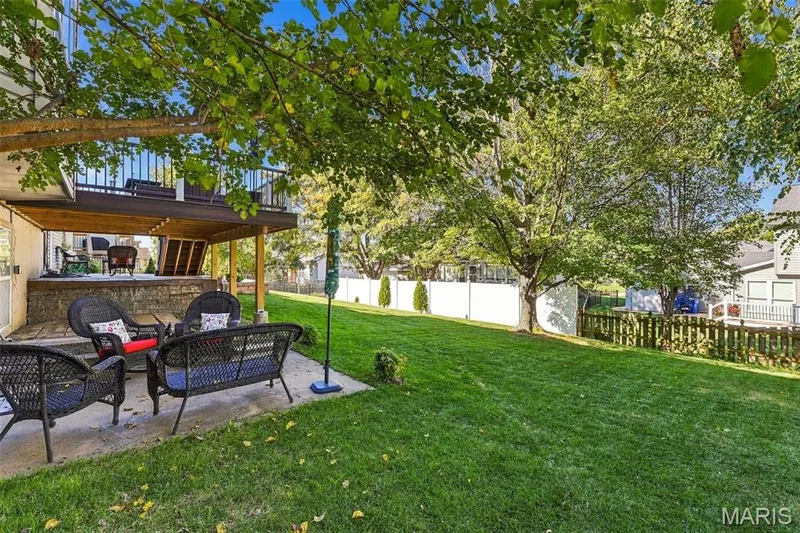 Walk out from the lower level with 2nd patio, fenced yard and mature trees for privacy and shade — 5872 Wellington Farm Drive, St Charles, MO 63304