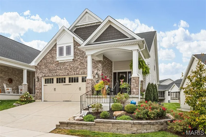 Brick and siding exterior with gabled rooflines, an attached garage, and a covered front entry — 17028 Fire Glow Drive, Ballwin, MO 63011