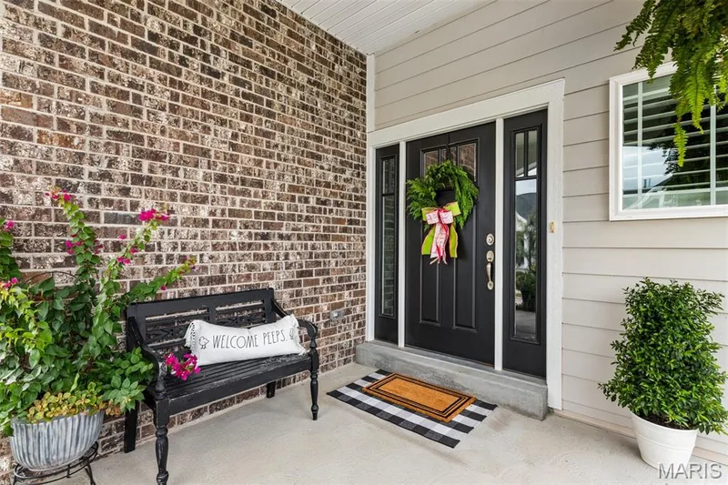 Brick and siding exterior with a concrete porch — 17028 Fire Glow Drive, Ballwin, MO 63011