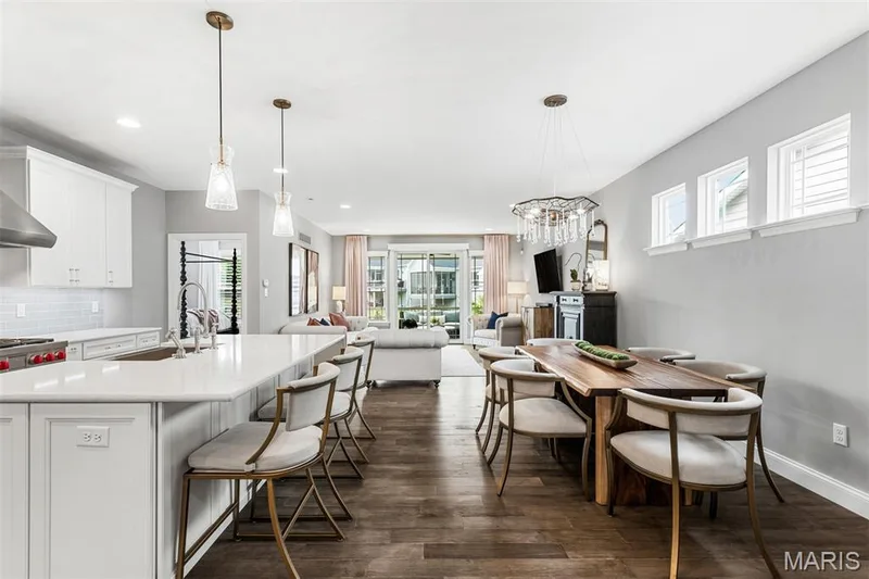 Open-concept living space with wood-finish flooring — 17028 Fire Glow Drive, Ballwin, MO 63011