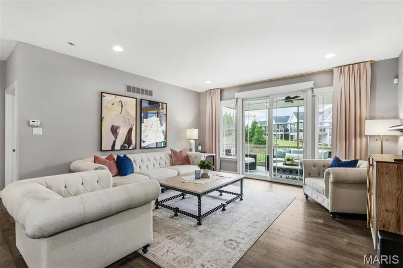 Recessed lighting illuminates the living space featuring wood-finish flooring — 17028 Fire Glow Drive, Ballwin, MO 63011