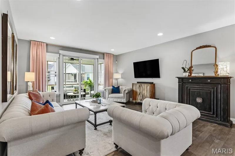 Recessed lighting illuminates the living area with wood-finish flooring — 17028 Fire Glow Drive, Ballwin, MO 63011
