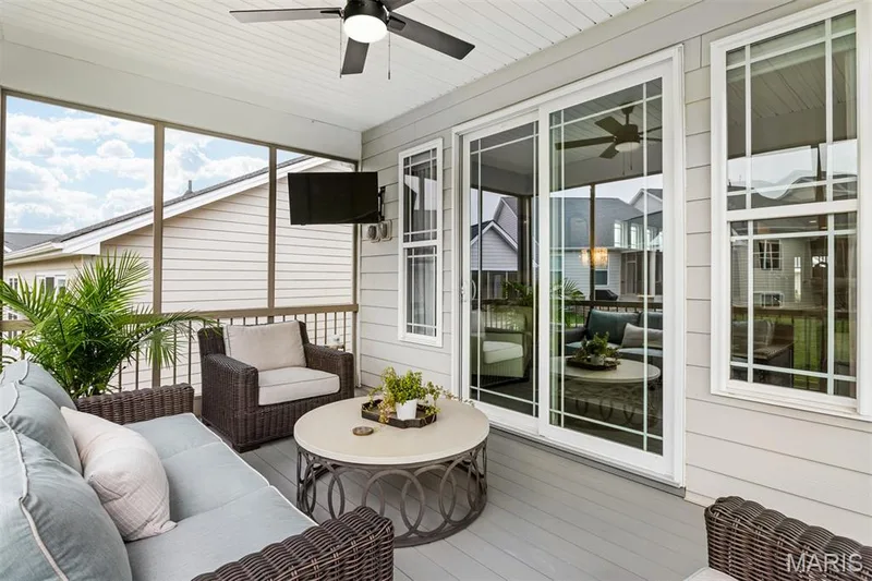 Screened porch with a ceiling fan, white paneled ceiling, and light gray flooring — 17028 Fire Glow Drive, Ballwin, MO 63011