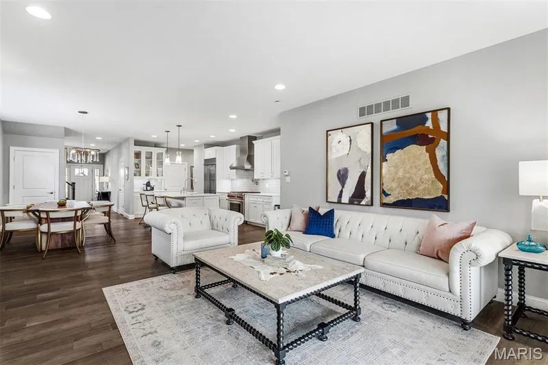 Expansive open-concept living area with wood-finish flooring, recessed lighting, and a neutral color palette — 17028 Fire Glow Drive, Ballwin, MO 63011