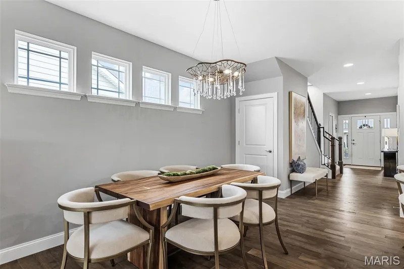 Wood-finish flooring throughout, multiple transom windows, and a decorative chandelier — 17028 Fire Glow Drive, Ballwin, MO 63011