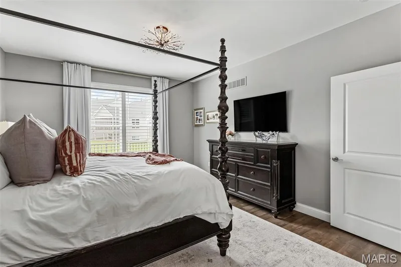 Wood-finish flooring, recessed lighting, ceiling-mounted light fixture, white interior door, and a large window with blinds — 17028 Fire Glow Drive, Ballwin, MO 63011