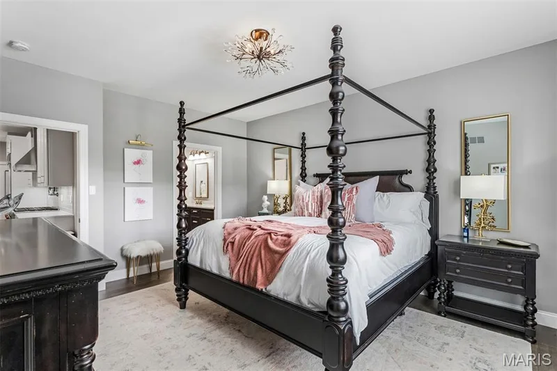Hardwood-style flooring, tray ceiling, chandelier lighting, and a neutral wall color — 17028 Fire Glow Drive, Ballwin, MO 63011