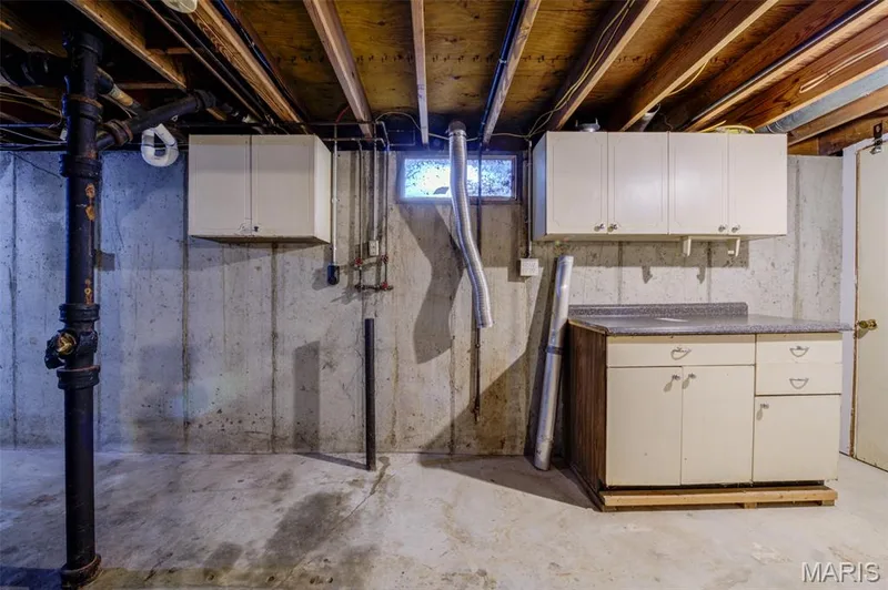 Laundry area in the basement with shelving. — 3215 Janton Lane, St Charles, MO 63301