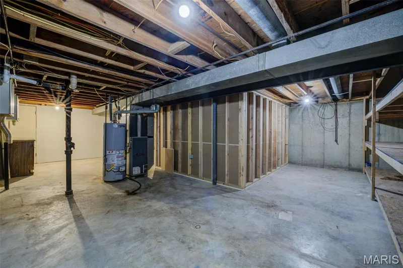 Basement with lots of storage shelves.  Finished room to the right of the furnace. — 3215 Janton Lane, St Charles, MO 63301