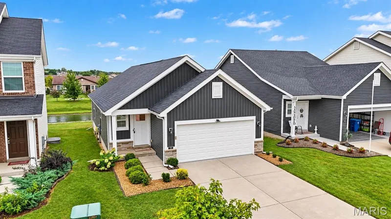 Modern exterior with dark siding, white trim, and a concrete driveway — 284 Crestfield Court, St Charles, MO 63301
