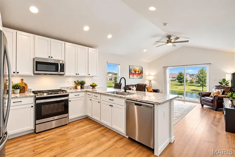 Contemporary kitchen with white cabinetry, stainless steel appliances, and light-toned countertops — 284 Crestfield Court, St Charles, MO 63301