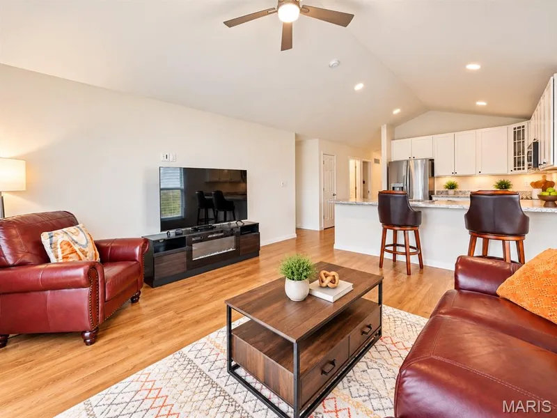 Open-concept living space featuring wood-finish flooring, recessed lighting, and a ceiling fan — 284 Crestfield Court, St Charles, MO 63301