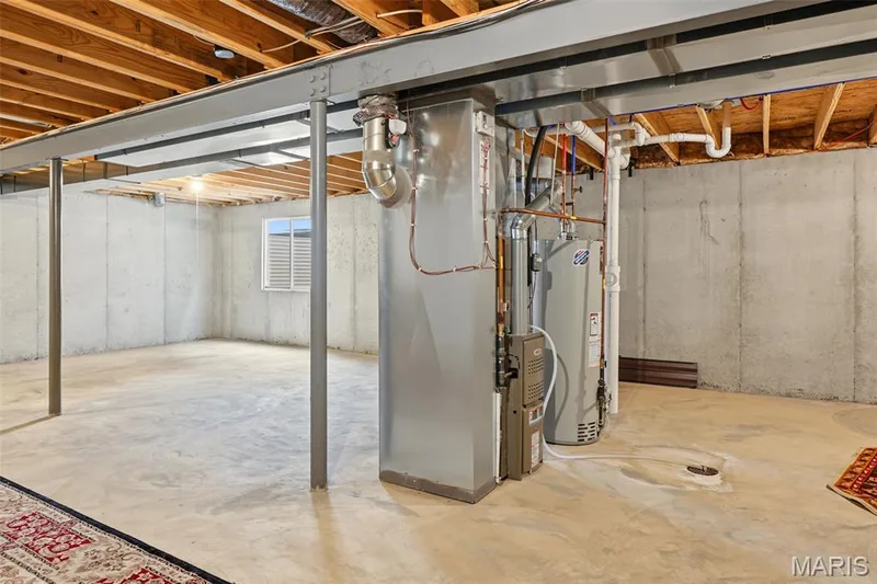 Unfinished basement featuring exposed wood joists, concrete walls, and structural support beams — 284 Crestfield Court, St Charles, MO 63301