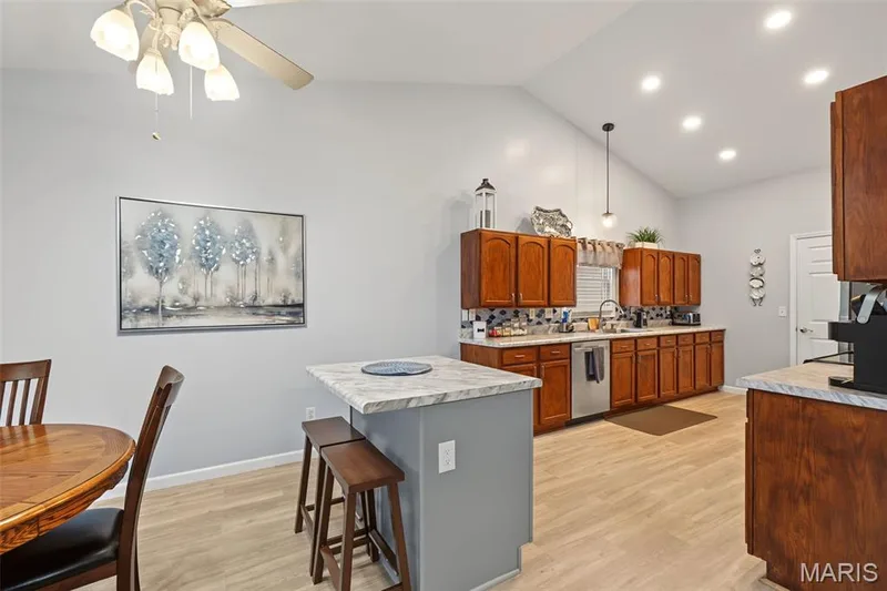 Wood-finish flooring, vaulted ceilings, recessed lighting, wood cabinetry, and stainless steel appliances — 8 Soenker Circle, St Peters, MO 63376