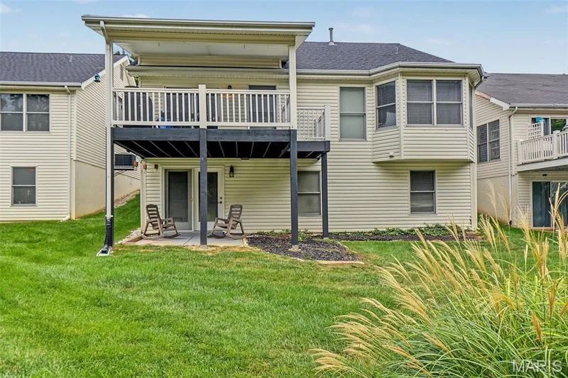 Upper-level deck with a white railing and covered roof — 8 Soenker Circle, St Peters, MO 63376