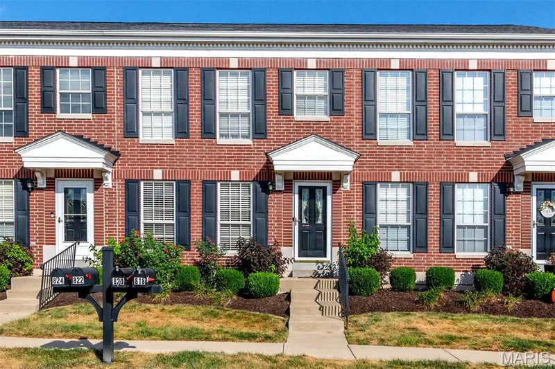 Red brick facade with black louvered shutters, white window trim, and a white cornice — 820 Brookmead Drive, O'Fallon, MO 63366