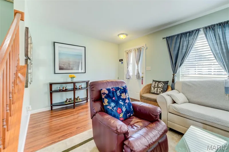 Wood-finish flooring throughout, light wall color, white trim, and a window with blinds — 820 Brookmead Drive, O'Fallon, MO 63366
