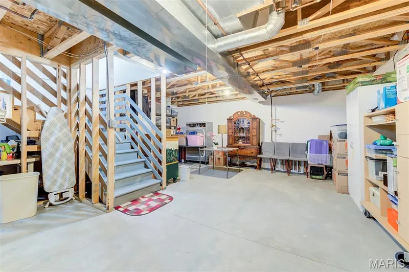Unfinished basement featuring exposed wood joists and structural beams — 820 Brookmead Drive, O'Fallon, MO 63366