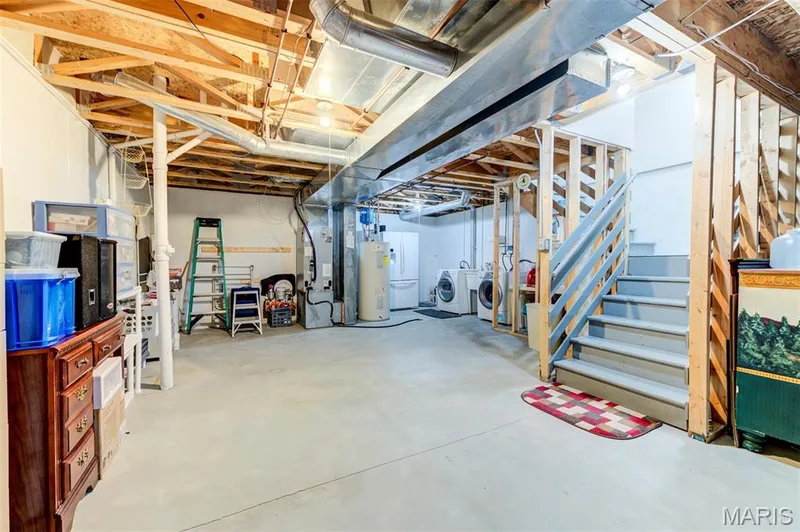 Unfinished basement with exposed ceiling joists and concrete flooring — 820 Brookmead Drive, O'Fallon, MO 63366