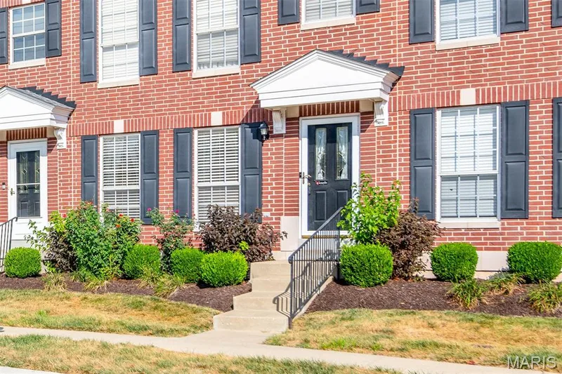 Brick exterior with black shutters and white window frames — 820 Brookmead Drive, O'Fallon, MO 63366