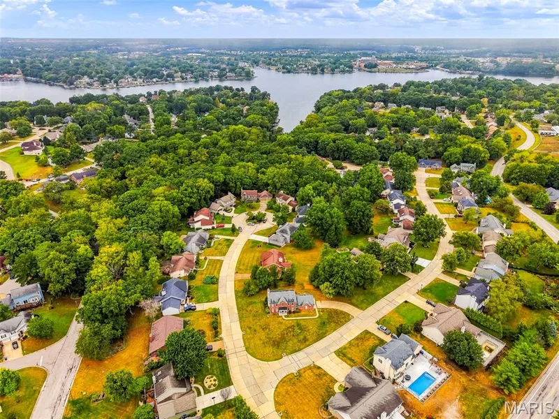 Aerial perspective of a residential neighborhood with mature trees and a nearby body of water — 11 Silver Leaf Court, Lake St. Louis, MO 63367