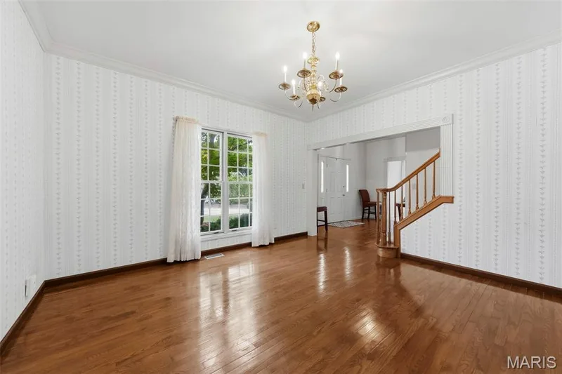 Hardwood flooring, crown molding, and a decorative chandelier — 11 Silver Leaf Court, Lake St. Louis, MO 63367