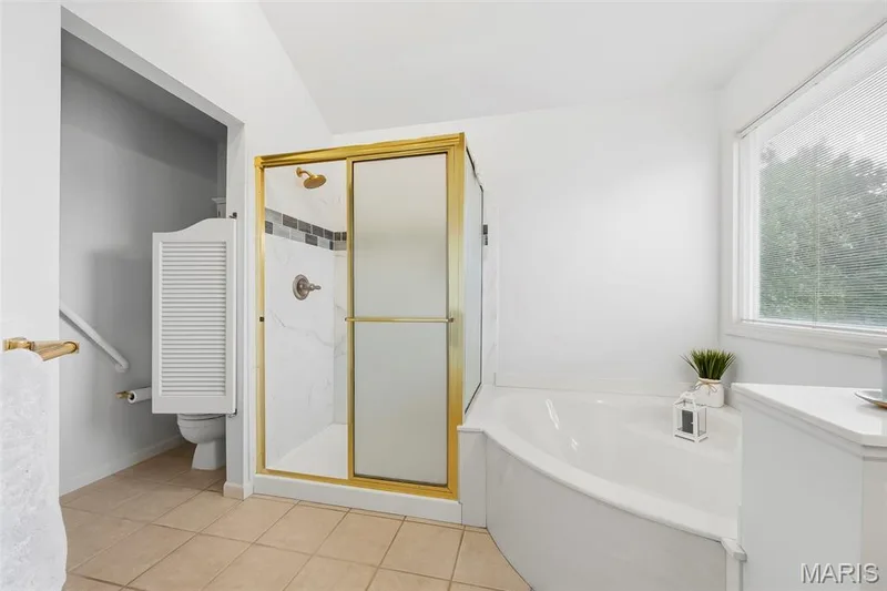 Tiled flooring and a corner soaking tub — 11 Silver Leaf Court, Lake St. Louis, MO 63367