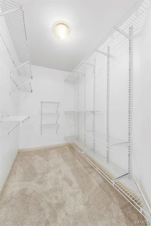 White wire shelving system, recessed ceiling light fixture, and light-toned carpet flooring — 11 Silver Leaf Court, Lake St. Louis, MO 63367