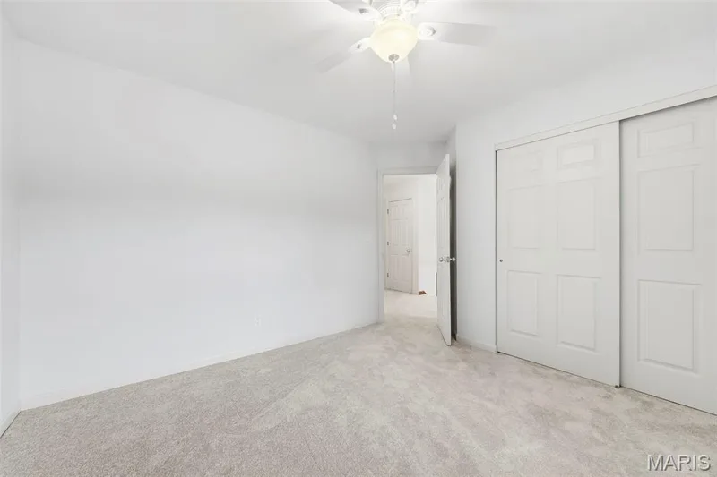 Neutral-toned carpeting, white painted walls, and a ceiling fan with integrated lighting — 11 Silver Leaf Court, Lake St. Louis, MO 63367