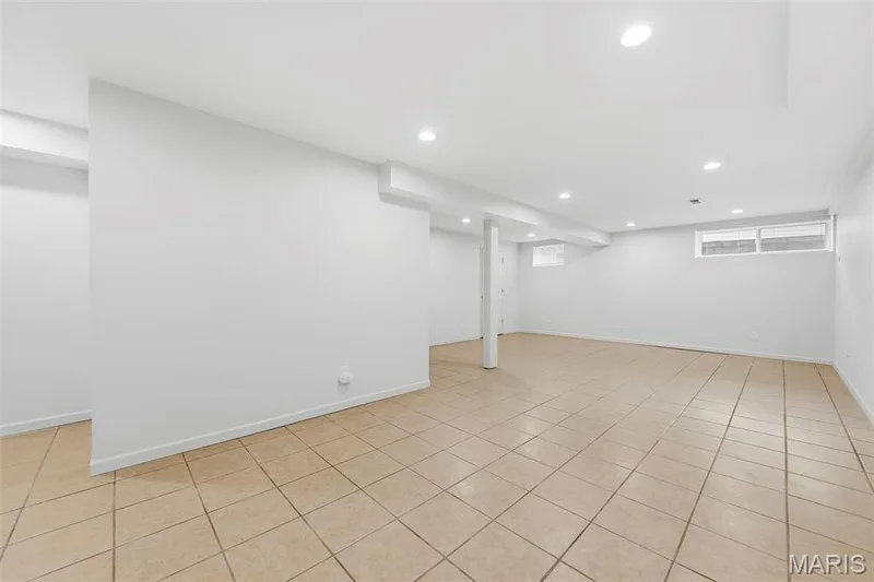 Spacious room featuring neutral-toned tile flooring, recessed ceiling lighting, and multiple windows — 11 Silver Leaf Court, Lake St. Louis, MO 63367