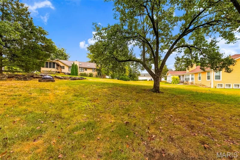 Expansive sloped lawn with mature trees and established landscaping — 11 Silver Leaf Court, Lake St. Louis, MO 63367