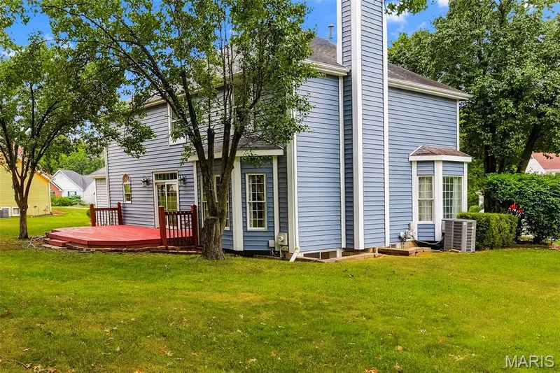 Exterior siding, multi-level deck, bay window, and a prominent chimney structure — 11 Silver Leaf Court, Lake St. Louis, MO 63367
