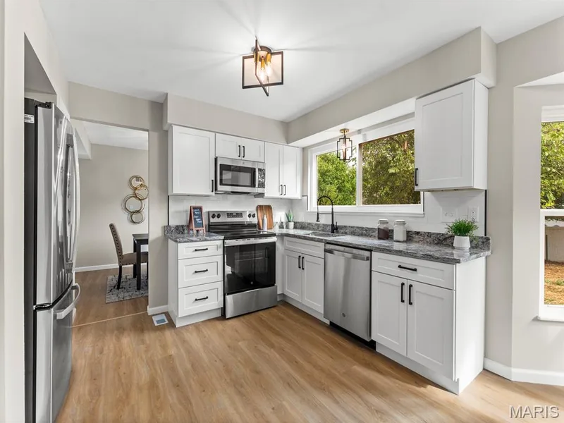 All New Kitchen with Custom White shaker cabinetry, granite countertops and new stainless steel appliances — 920 Blake Court, St Peters, MO 63376