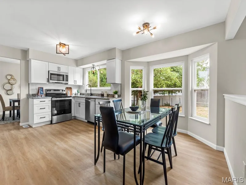 Open-concept kitchen and dining area with new windows — 920 Blake Court, St Peters, MO 63376