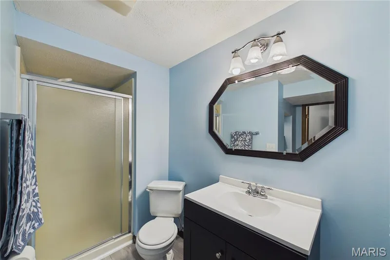 Built-in vanity with integrated sink, chrome faucet, and storage cabinetry w/full walk-in shower — 2931 Plum Leaf Circle, St Peters, MO 63303