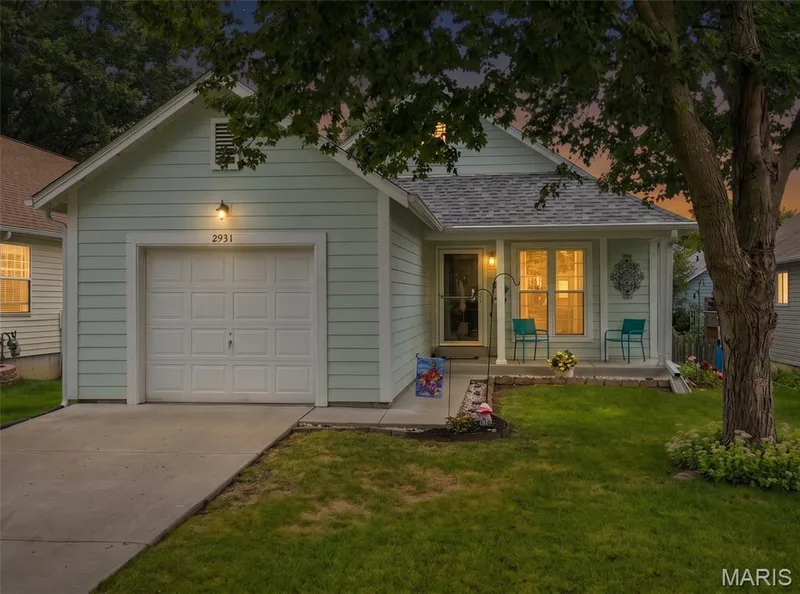WELCOME HOME! Light colored siding, white trim, white garage door, and a front covered porch — 2931 Plum Leaf Circle, St Peters, MO 63303