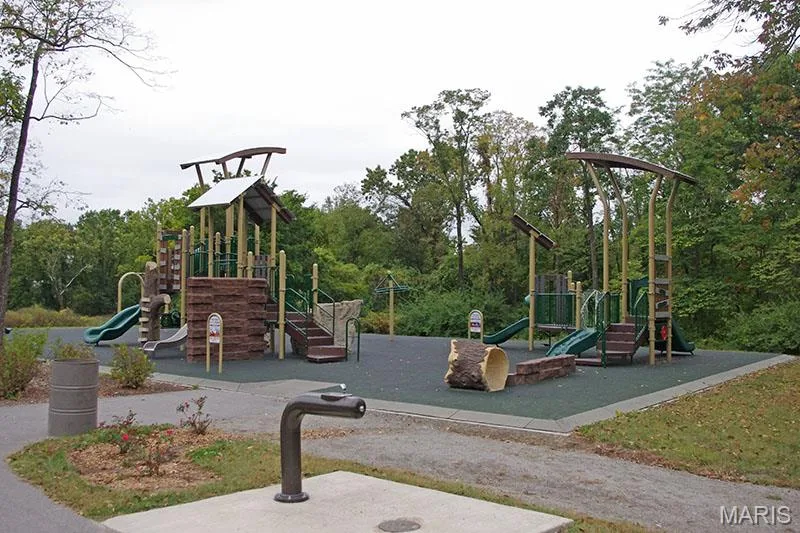 Expansive outdoor playground featuring multiple slides, climbing structures, and a durable rubberized surface — 202 Kunze Drive, St Charles, MO 63303