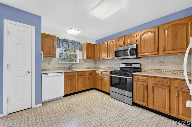 Kitchen Area with Pantry, Backsplash, Window, Lots of Cabinet/Counter Space — 1436 Snowbird Lane, O'Fallon, MO 63366