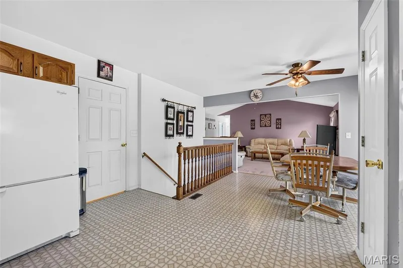 View from Kitchen into the Living Room and Stairs down to the Lower Level — 1436 Snowbird Lane, O'Fallon, MO 63366