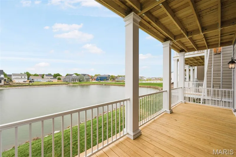 Expansive outdoor deck with wood flooring and white railing — 9023 Wilkie Station Street, St Charles, MO 63301