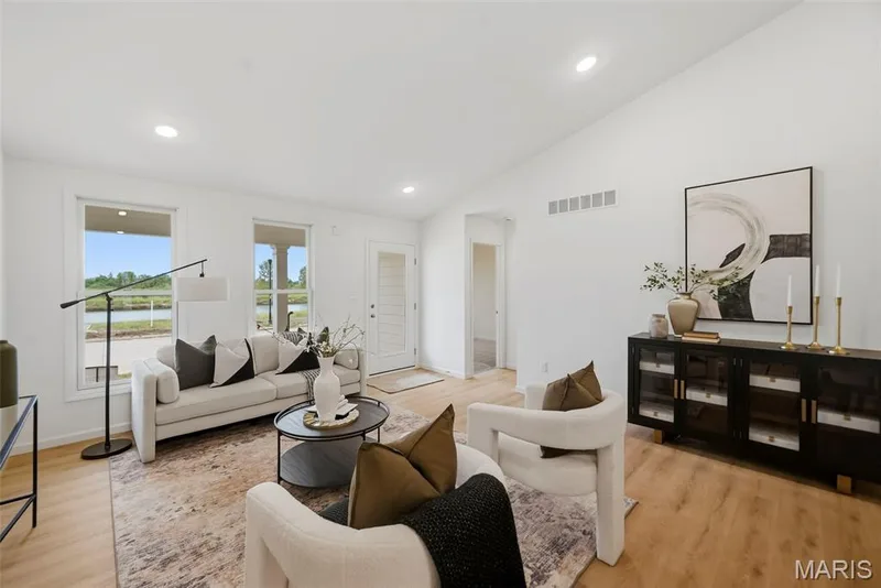 Vaulted ceilings, recessed lighting, and LVP flooring — 9023 Wilkie Station Street, St Charles, MO 63301