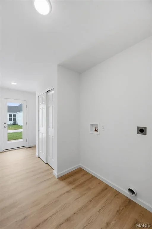 LVP flooring, recessed lighting, and a white bi-fold closet — 9023 Wilkie Station Street, St Charles, MO 63301
