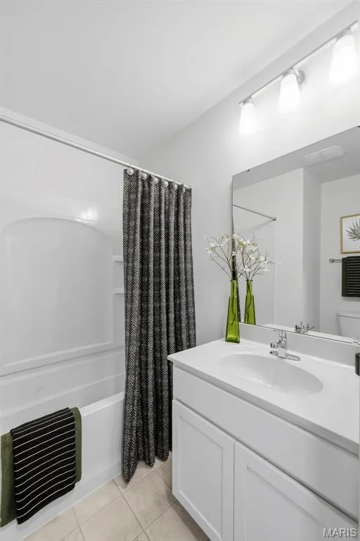 White vanity with a single basin sink, chrome faucet, and integrated countertop — 9023 Wilkie Station Street, St Charles, MO 63301