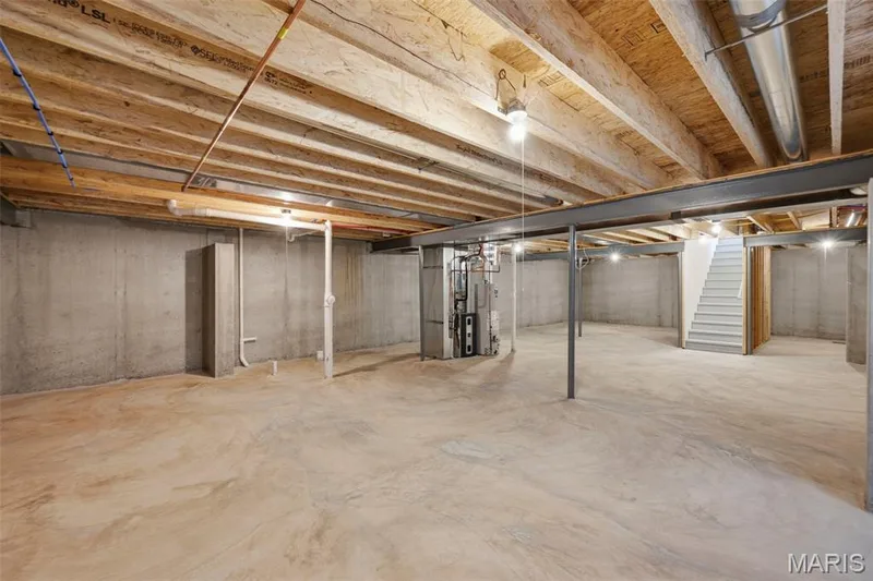 Unfinished basement with concrete walls, exposed ceiling joists, and a concrete floor — 9023 Wilkie Station Street, St Charles, MO 63301