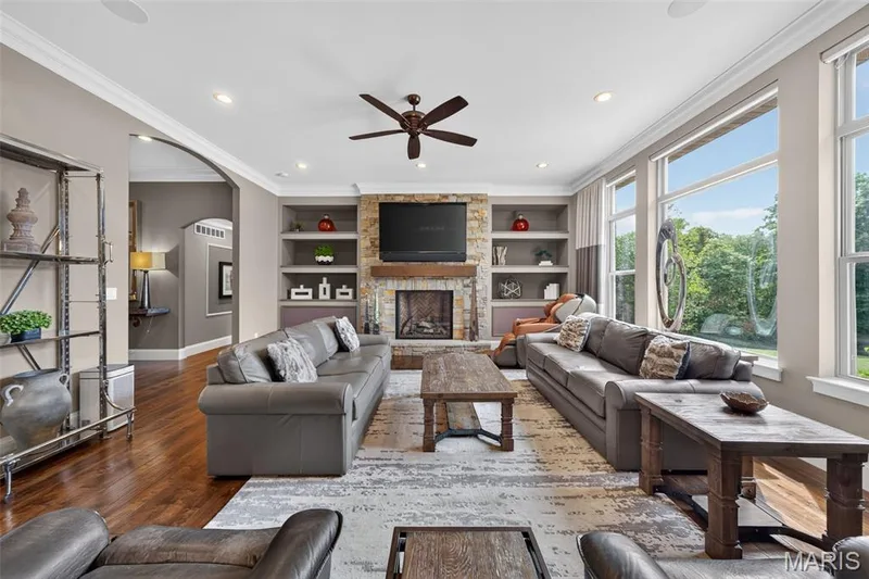 Floor to ceiling gas stone fireplace flanked by built in shelving — 2000 Diehr Road, Wentzville, MO 63385