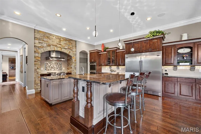 2 kitchen islands. Prep island is standard height, entertainment island has motorized pop up TV built into the island at bar height — 2000 Diehr Road, Wentzville, MO 63385