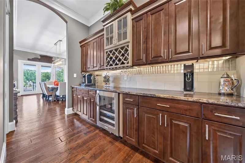 Butlers pantry with beverage cooler and granite countertops — 2000 Diehr Road, Wentzville, MO 63385