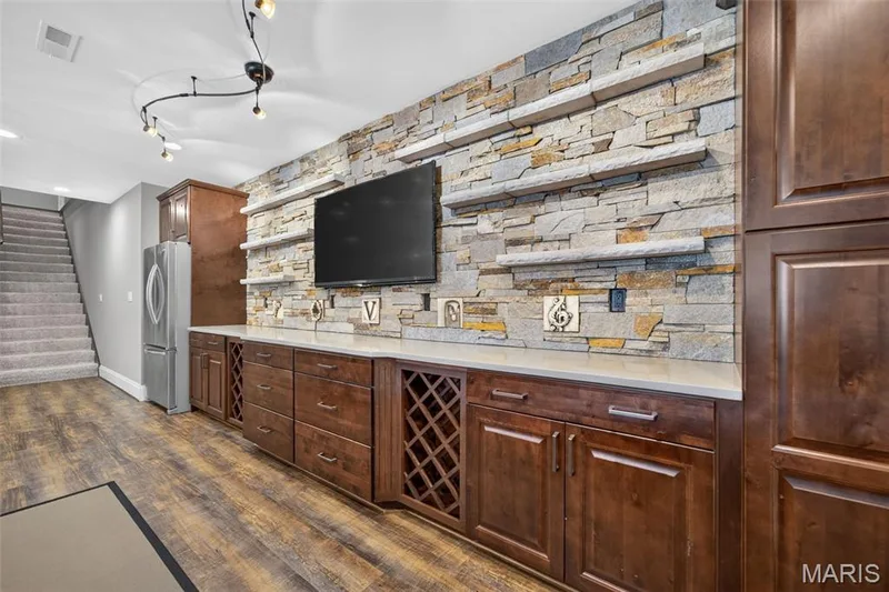 Stacked stone feature wall with ledge stone shelves for display — 2000 Diehr Road, Wentzville, MO 63385