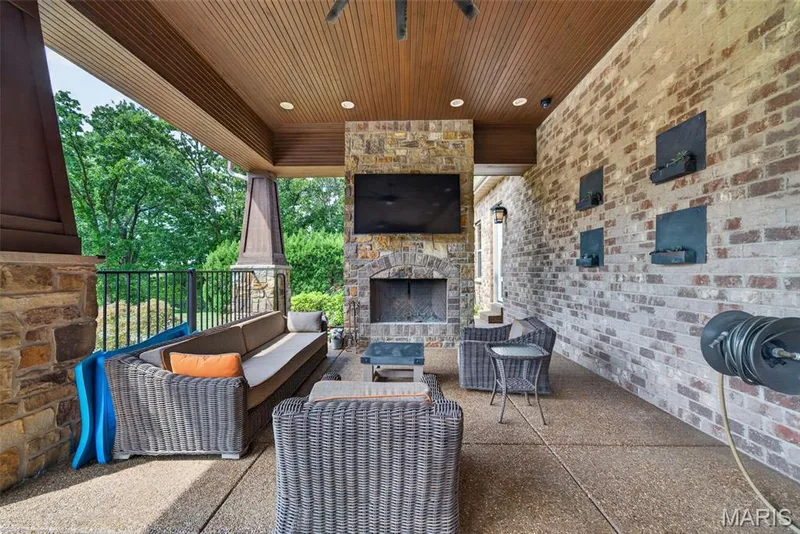 40x18' Outdoor covered patio with exposed aggregate floor and wood burning fireplace — 2000 Diehr Road, Wentzville, MO 63385