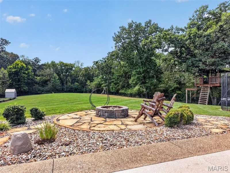Round raised fire pit with flagstone surround, one of 2 fire pit areas — 2000 Diehr Road, Wentzville, MO 63385